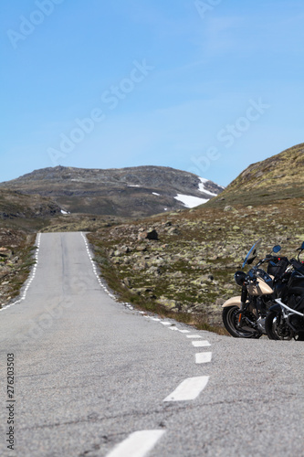 Norwegian Scenic Route Aurlandsfjellet 243 runs across the mountains. Motorcycles parked on a roadside  white line. Norway  Scandinavia