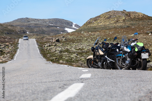 Norwegian Scenic Route Aurlandsfjellet 243 runs across the mountains. Motorcycles parked on roadside, white line. Norway, Scandinavia