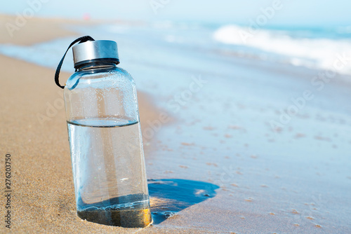 reusable water bottle on the beach