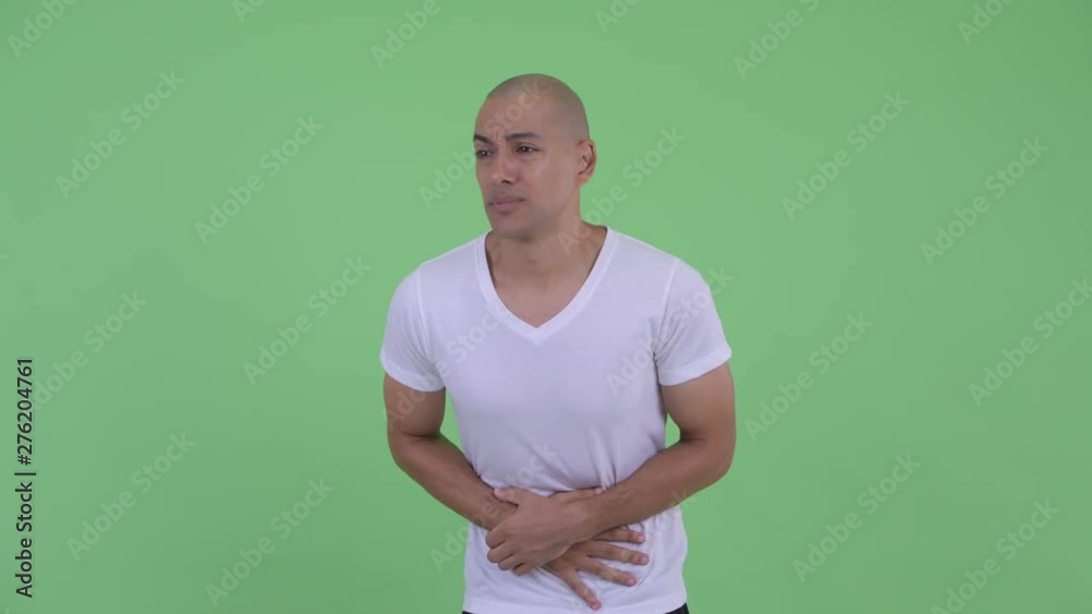 Stressed bald man having stomachache Stressed bald man having stomachache