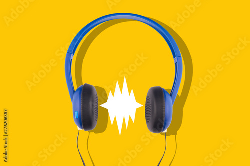 blue headphones isolated on yellow background photo