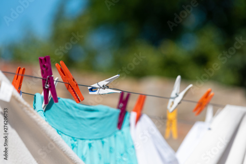 Clean laundry dried hang over on the wire, clips and laundry close up