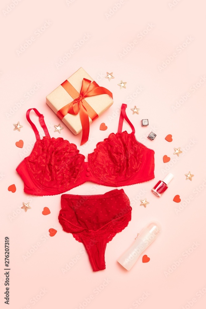 Red female underwear with sex lubricant, cubes, surprise box with a gift  and a red ribbon on a pink background. Stock Photo | Adobe Stock