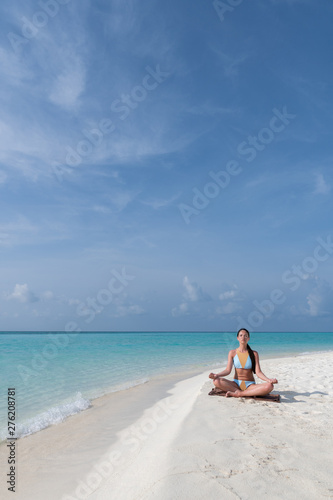 Meditation - Yoga woman meditating at serene beach.
