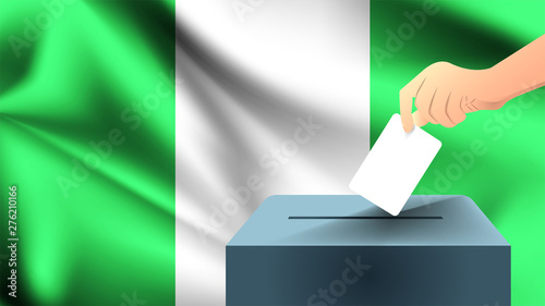 Male hand puts down a white sheet of paper with a mark as a symbol of a ballot paper against the background of the Nigeria flag, nigeria the symbol of elections