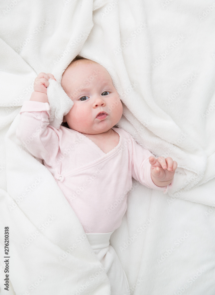 Baby Girl lie in bed, Newborn Child Covered By white Blanket, copy space Baby Girl lie in bed, Newborn Child Covered By white Blanket, copy space