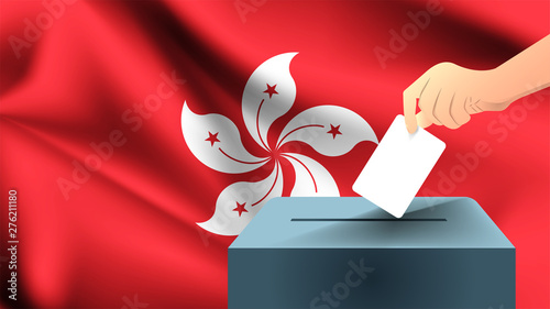 Male hand puts down a white sheet of paper with a mark as a symbol of a ballot paper against the background of the Hong kong flag, hong kong the symbol of elections