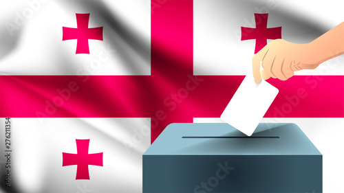 Male hand puts down a white sheet of paper with a mark as a symbol of a ballot paper against the background of the Georgia flag, georgia the symbol of elections