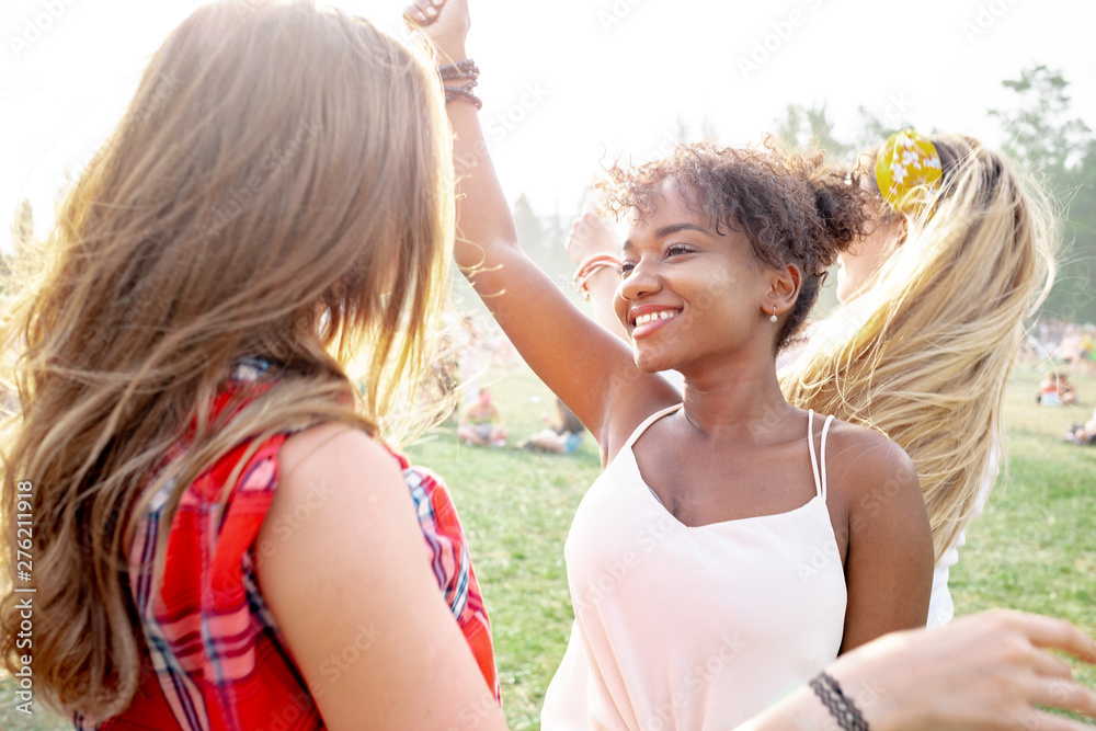 African American young woman with friends at summer music festival African American young woman with friends at summer music festival