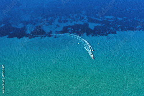 Aerial view of speed boat in motion. Water transportation and summer leisure time activity.
