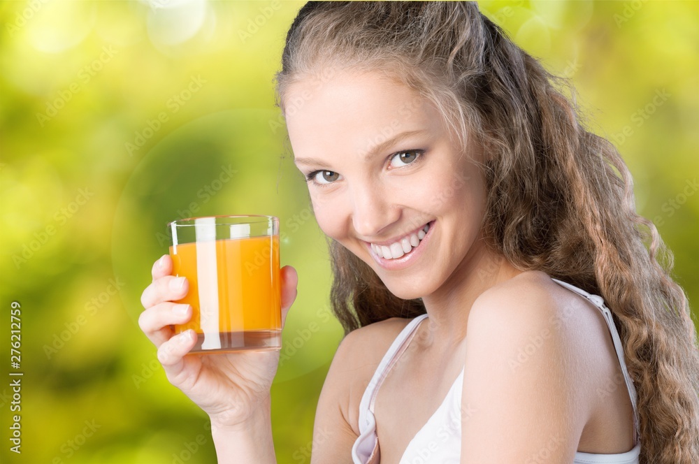 Young woman drinking water on blurred background Young woman drinking water on blurred background