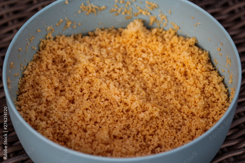 Large bowl with cooked Morocco Couscous mixed with olive oil and paprika powder Large bowl with cooked Morocco Couscous mixed with olive oil and paprika powder