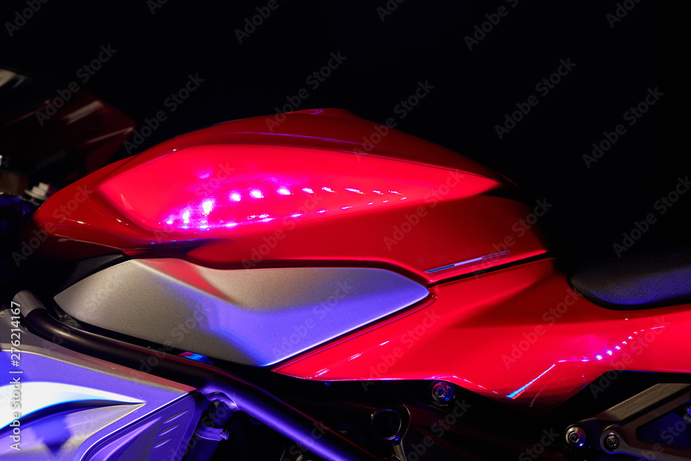 Motorcycle sportbike on a black background. The front part with the tank.