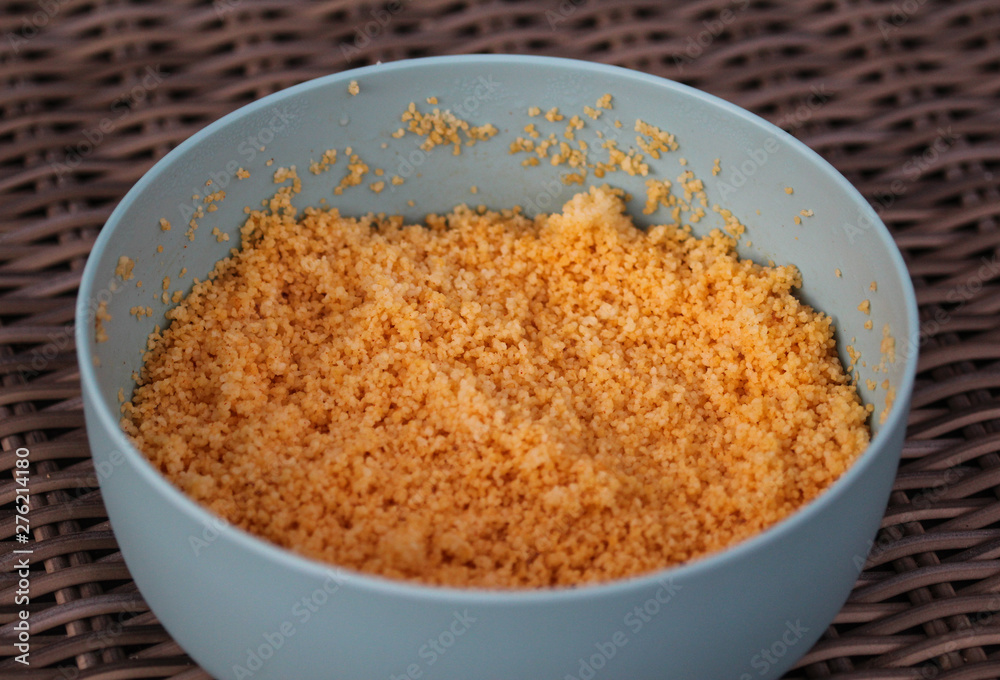 Large bowl with cooked Morocco Couscous mixed with olive oil and paprika powder Large bowl with cooked Morocco Couscous mixed with olive oil and paprika powder