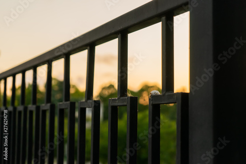 Sunset over the metal fence