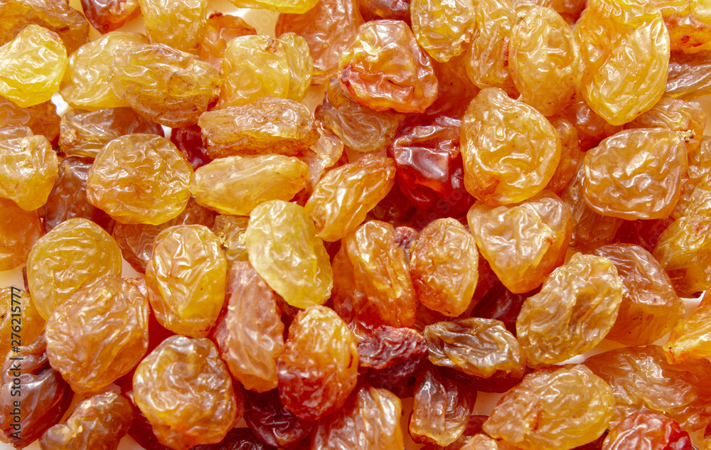Delicious, ripe raisins close up. Isolated on white background. Delicious, ripe raisins close up. Isolated on white background.