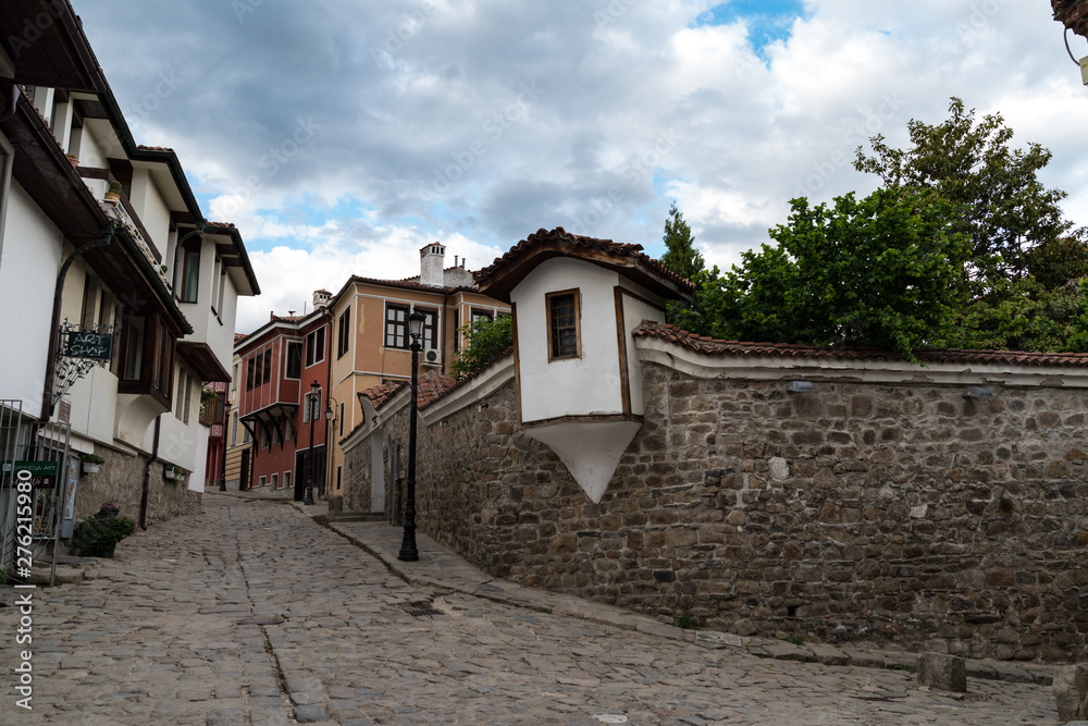 View of a narrow street in historical part of Plovdiv Old Town. Typical medieval colorful buildings. Bulgaria View of a narrow street in historical part of Plovdiv Old Town. Typical medieval colorful buildings. Bulgaria