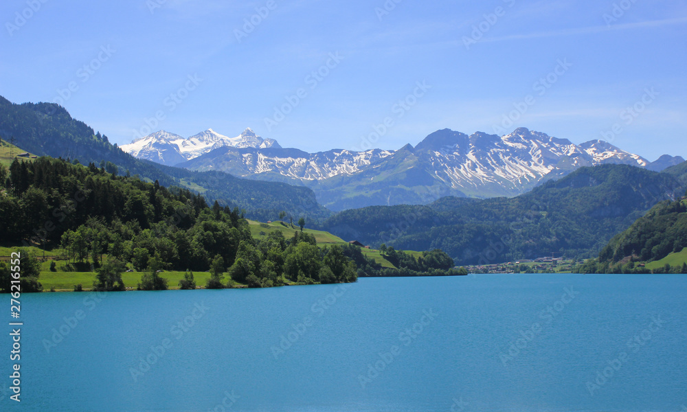 Lake Lungeren and mountain range. Early summer in Switzerland.