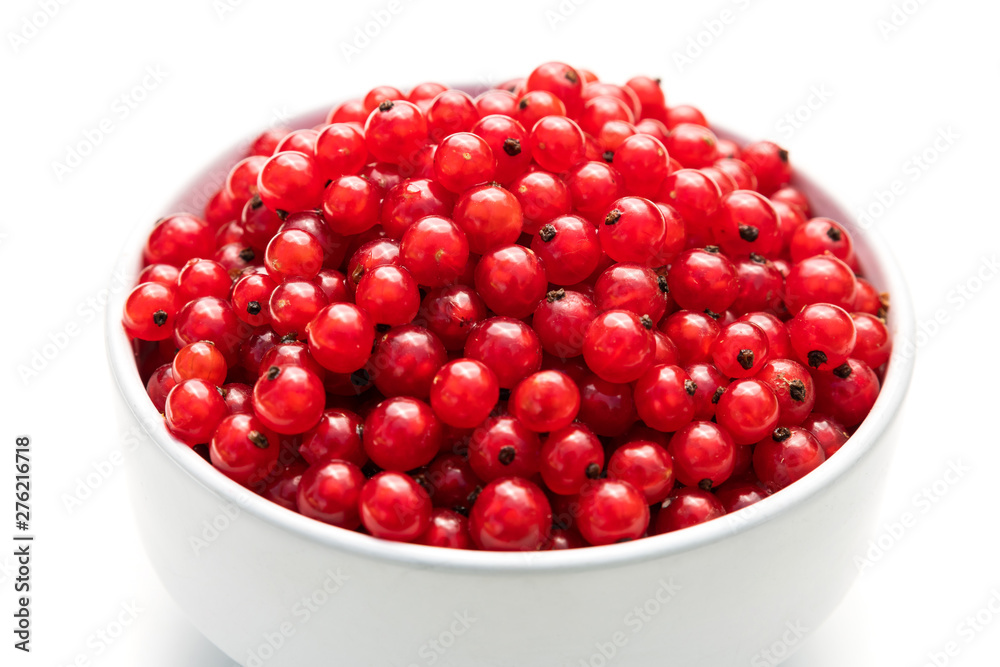 red currant in a white bowl on a white isolated background red currant in a white bowl on a white isolated background
