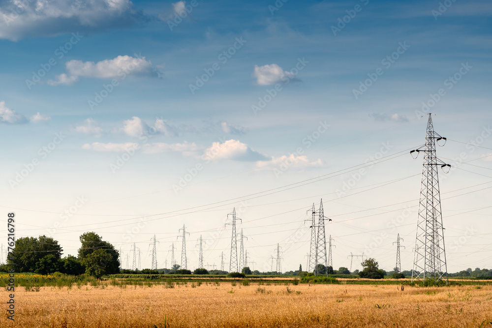 Power transmission lines and towers in the field in countryside