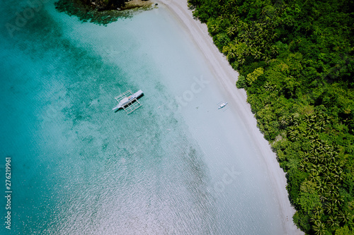 Aerial drone view of the beautiful paradise lagoon and white sand beach. Local boats on the surface. Summer exotic vacation concept © Igor Tichonow