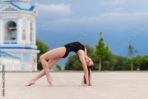 Girl gymnast, performs various gymnastic and fitness exercises.