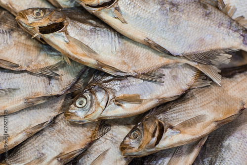 Dried fish background. Salty dry river fish top view with copy space photo