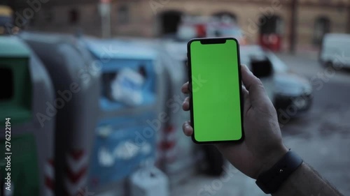 Wallpaper Mural Man hands using phone with vertical green screen on the back of the garbage containers smart mobile background view blurred display touchscreen outdoors business internet touch slow motion Torontodigital.ca
