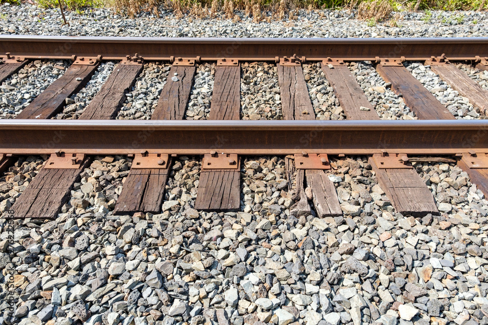 close up of section of the railway road with rusted on a sunny day close up of section of the railway road with rusted on a sunny day