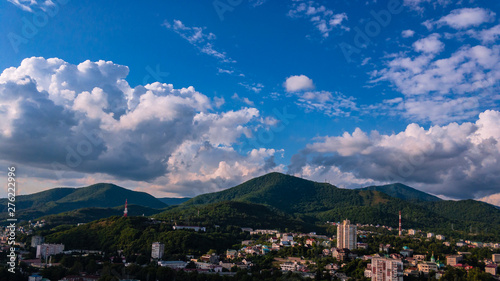City against the backdrop of mountains and blue sky. © Vit-Vit