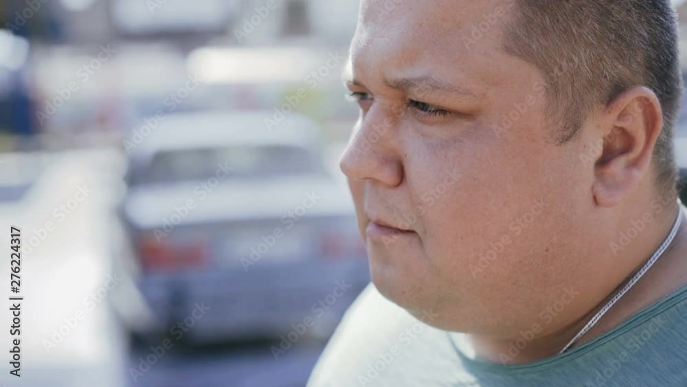 A smoking man is waiting for a car at a car wash A smoking man is waiting for a car at a car wash