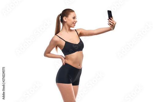 Cheerful slim woman posing for selfie
