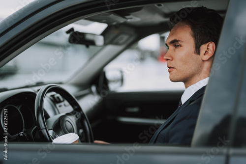 Young man sitting behind wheel of car © Yakobchuk Olena