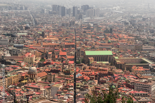 Fototapeta Naklejka Na Ścianę i Meble -  View of Spaccanapoli street splitting city center of Naples. Napoli city skyline with historical Old town, Spaccanapoli street and modern financial district skyscrapers, Italy.