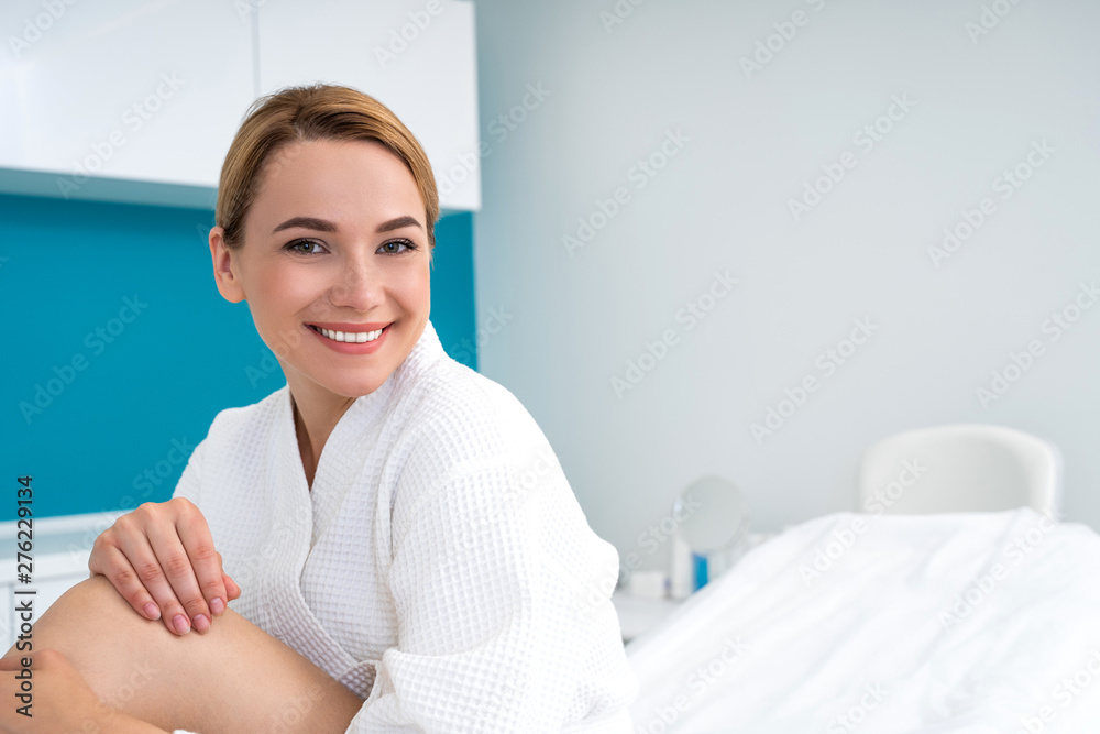 Positive young woman smiling in the medical office