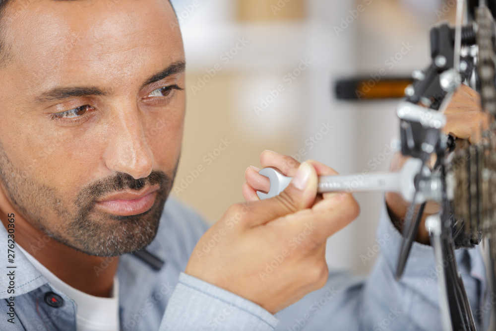 man repairing bicycle at home man repairing bicycle at home