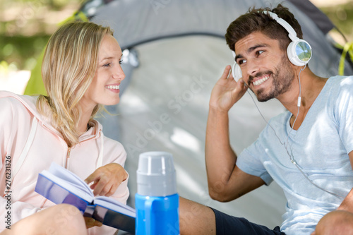 couple listening to music while camping