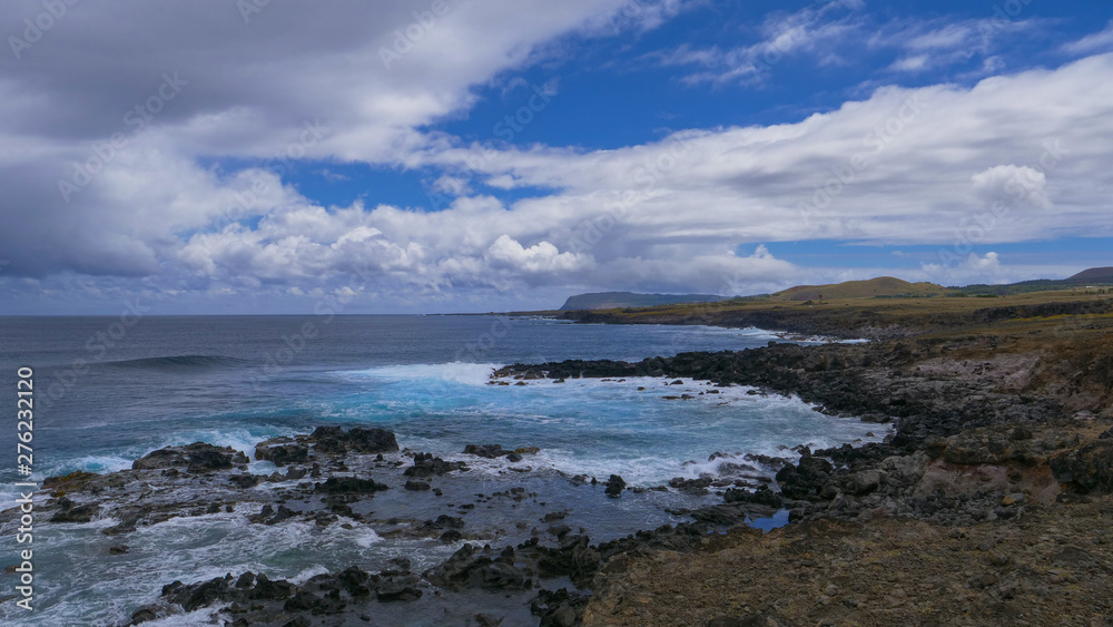 AERIAL: Picturesque view of the blue sky above the coastline of volcanic island.