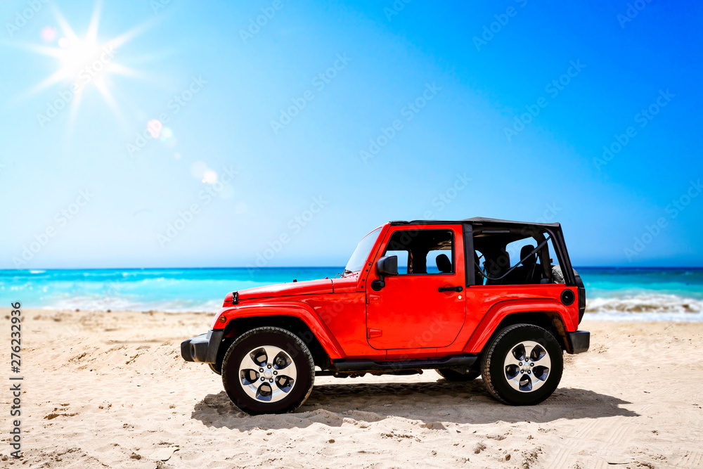 Fototapeta premium Summer red car on beach and sea landscape with blue sky and sun . 