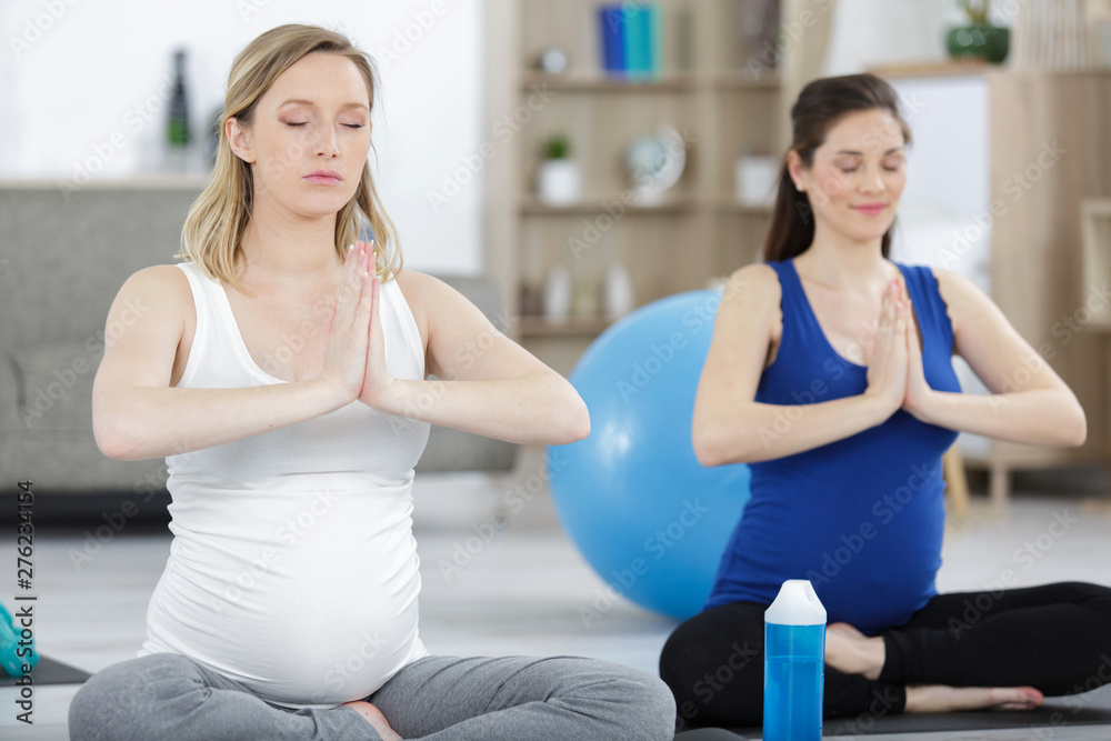 a pregnant women practicing yoga a pregnant women practicing yoga