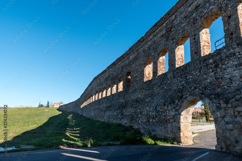 Aqueduct de San Lazaro, an ancient Roman aqueduct in Merida, Spain with a modern road