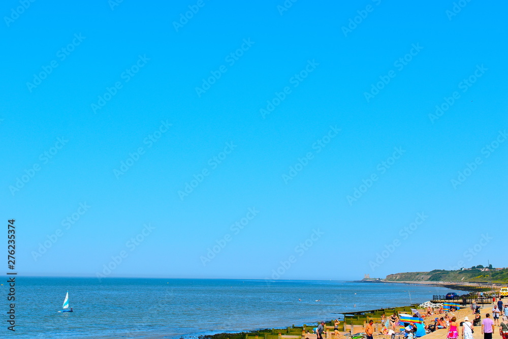 People enjoy the sunshine and hot weather on Herne Bay Central Beach in Kent. Herne Bay, Kent, UK
