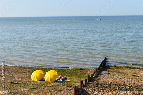 Sunseekers enjoying the hot summer weather across the UK. Herne Bay Beach, Kent, UK photo