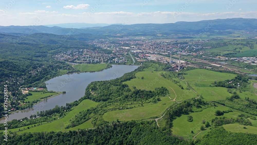 Aerial view of Slatina river near Motova river dam, central Slovakia. Cityscape of Zvolen city in background. Drone photo taken during early summer season