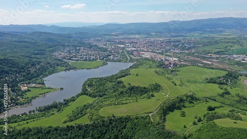 Aerial view of Slatina river near Motova river dam, central Slovakia. Cityscape of Zvolen city in background. Drone photo taken during early summer season