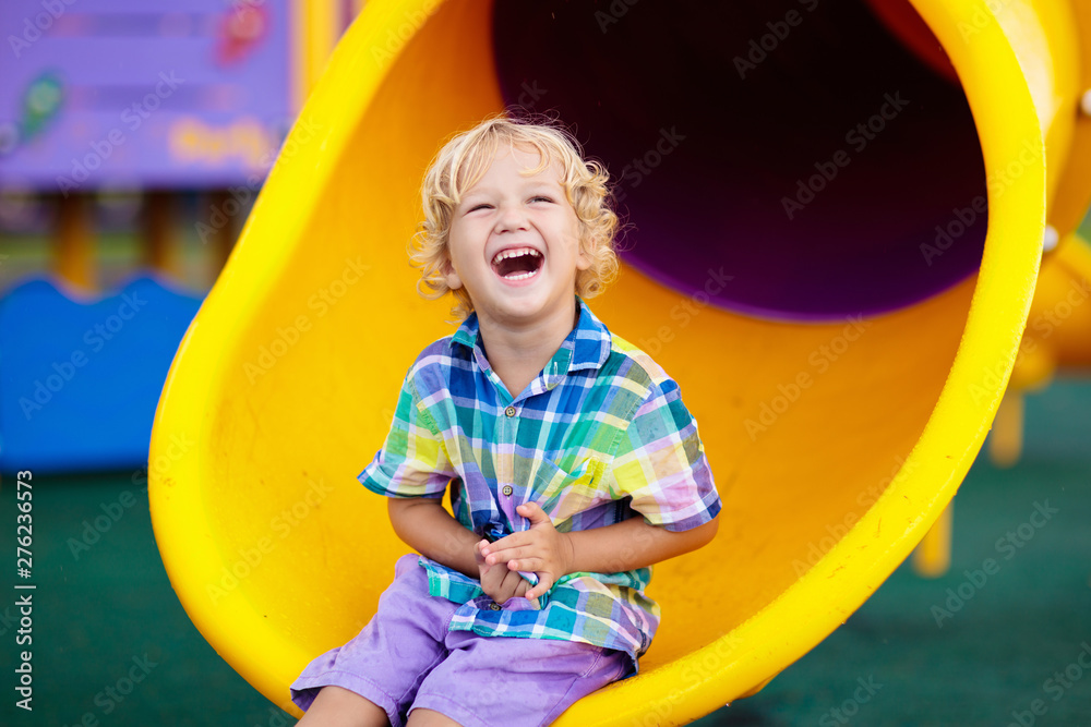 Child on playground. Kids play outdoor. Stock Photo | Adobe Stock