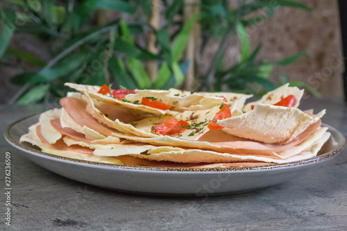 Pane carasau con olio tartufato, mortadella e pomodorini  photo