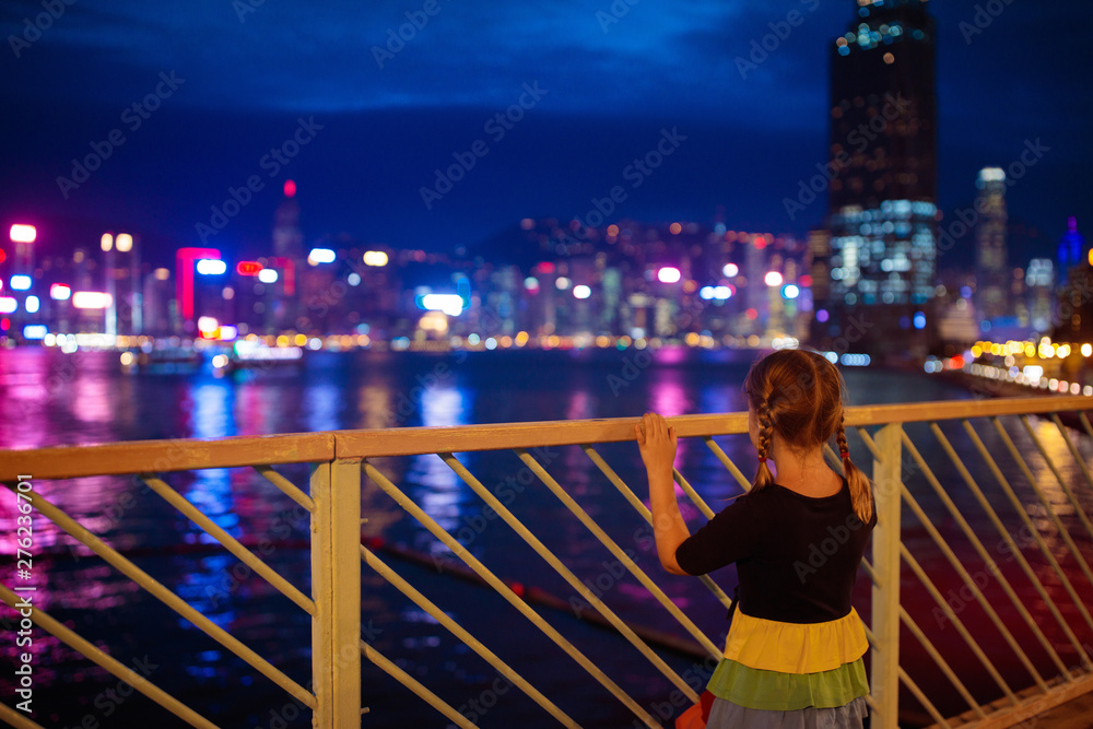 Kids watch Hong Kong harbor skyline.