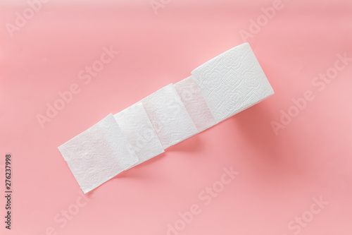 Toilet paper for proctology diseases concept on pink background top view