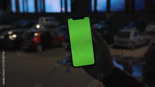 Wallpaper Mural Man holding use smartphone with vertical green screen on night city colorful light background car communication device hands digital gadget phone touchscreen traffic mobile slow motion Torontodigital.ca